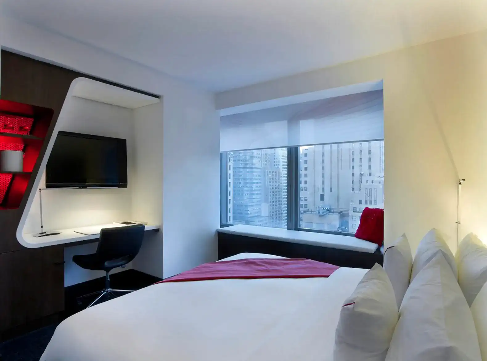 Modern bedroom with a large window and a workspace area