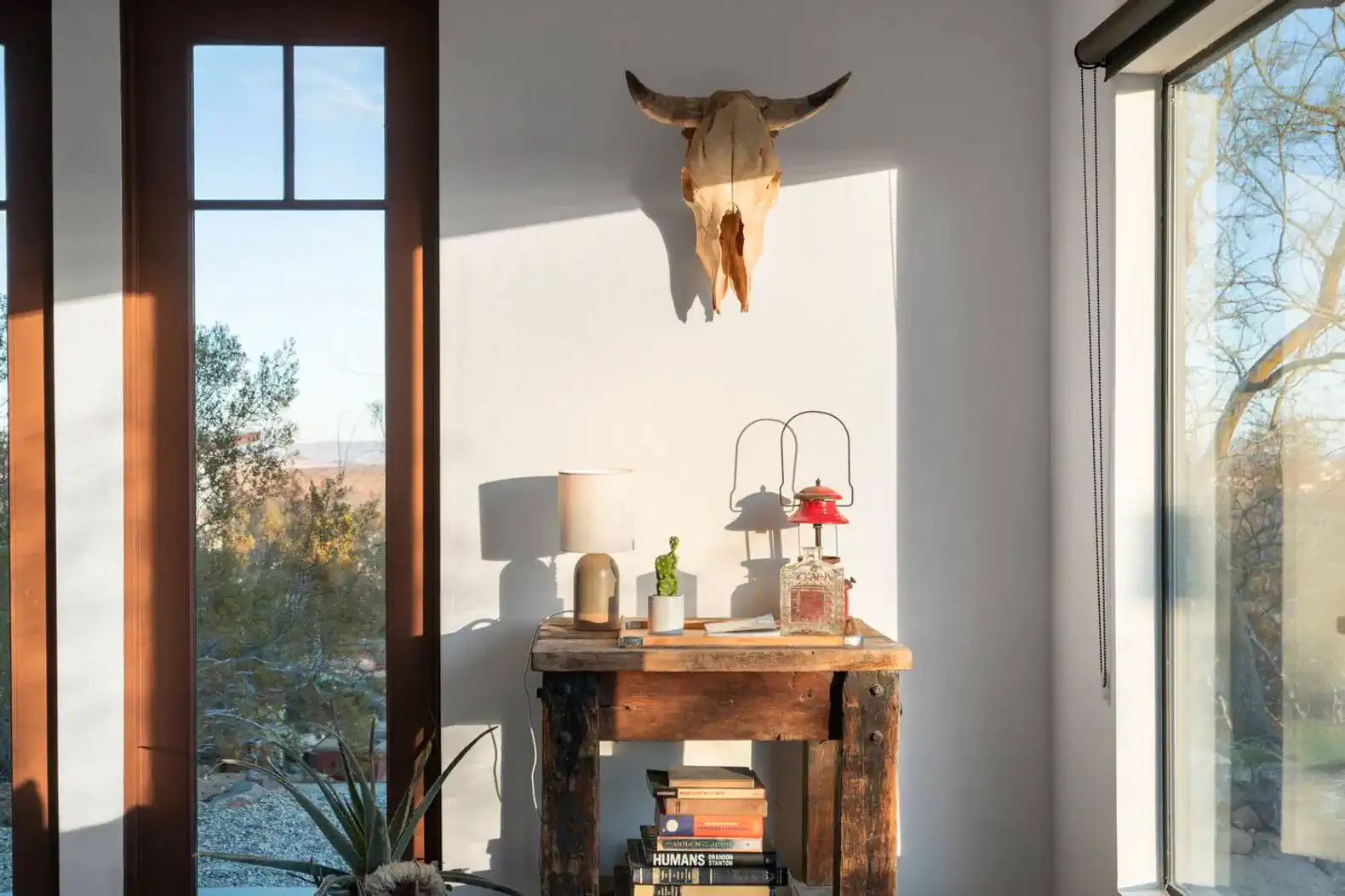 Rustic wooden table with decor and a view of the desert landscape