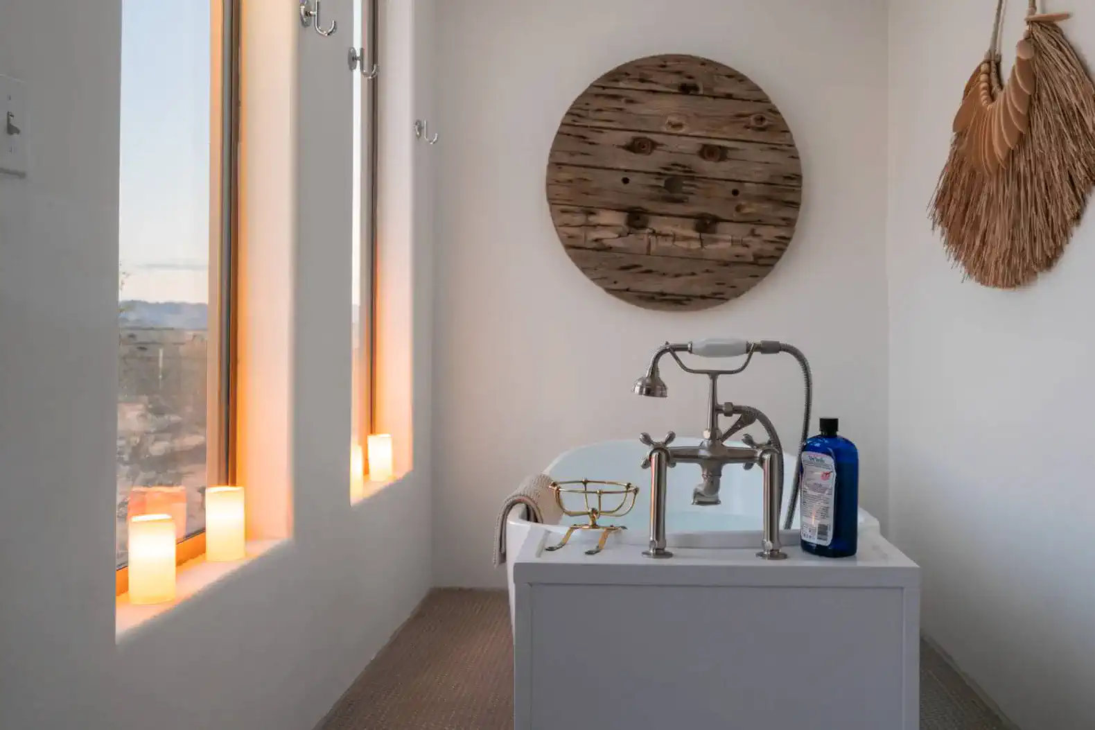 Stylish bathroom featuring a freestanding tub and large windows with natural light