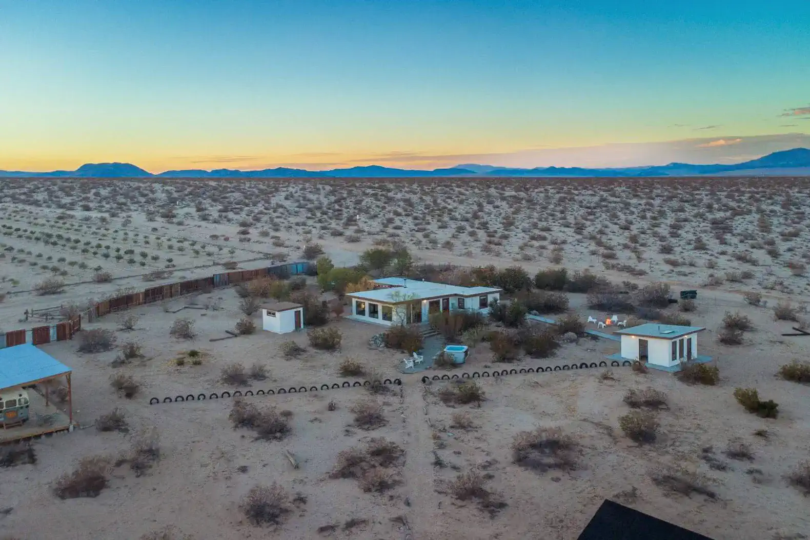 Aerial view of Desert's Edge surrounded by desert landscape and mountains in the distance