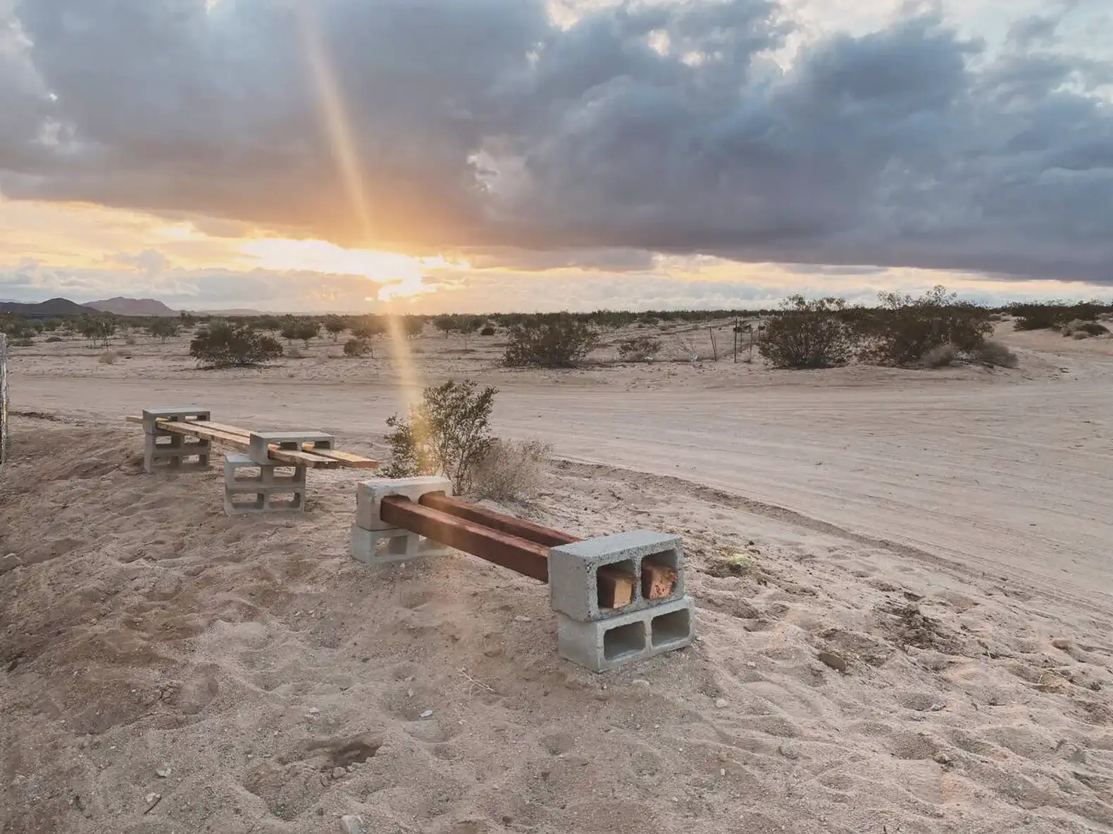 Desert landscape with benches and a stunning sunset