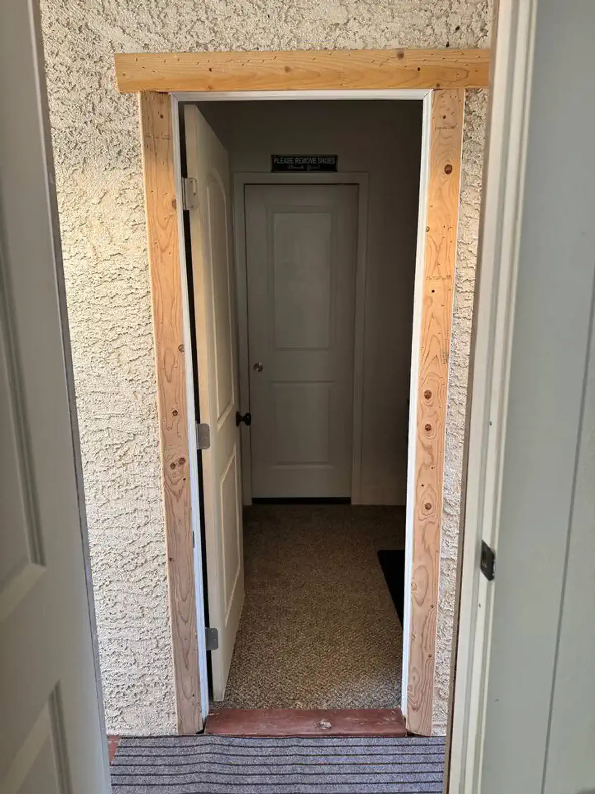 Entrance leading to a hallway with a door at the end