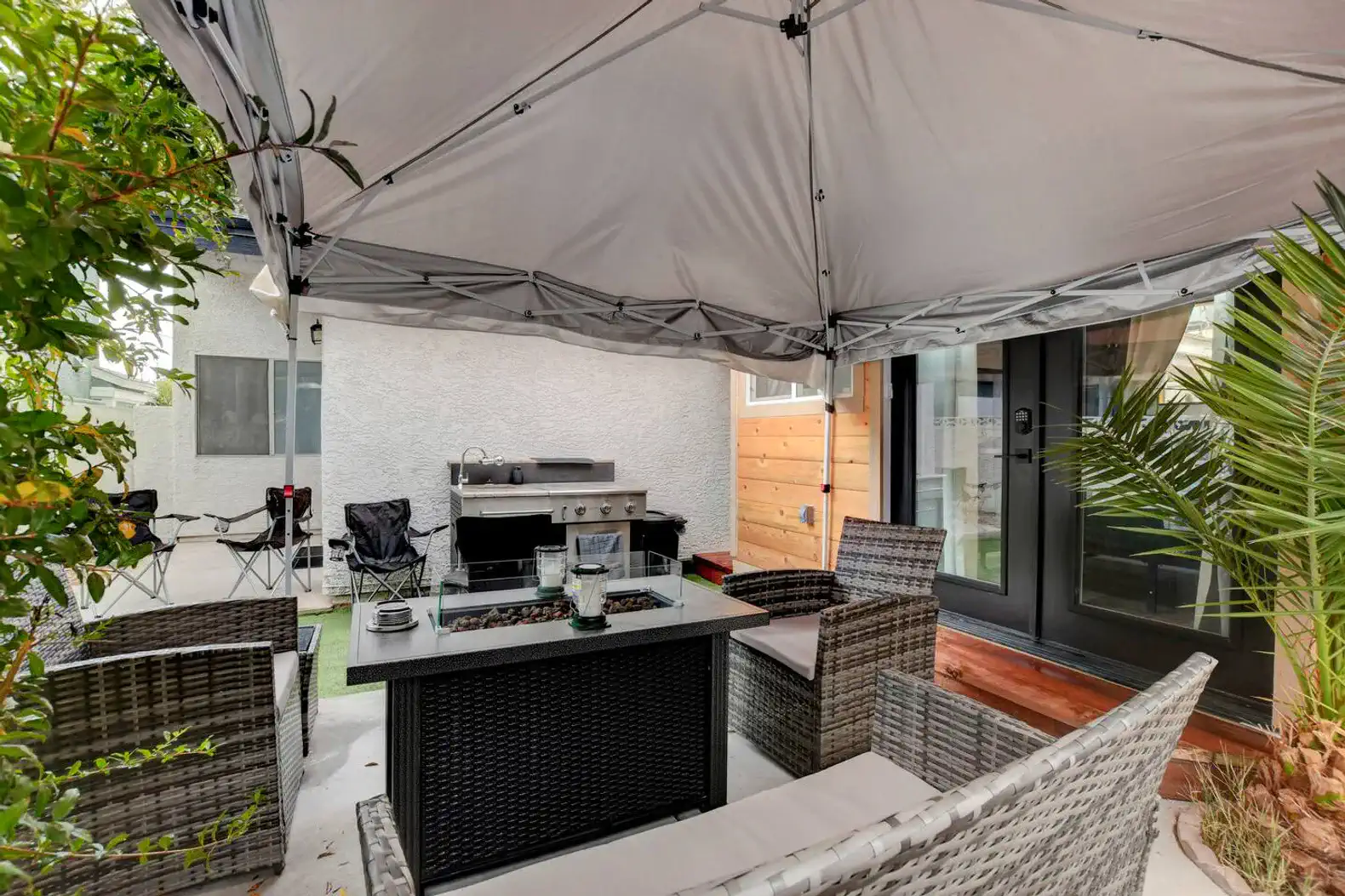 Cozy outdoor seating area with a fire pit and canopy