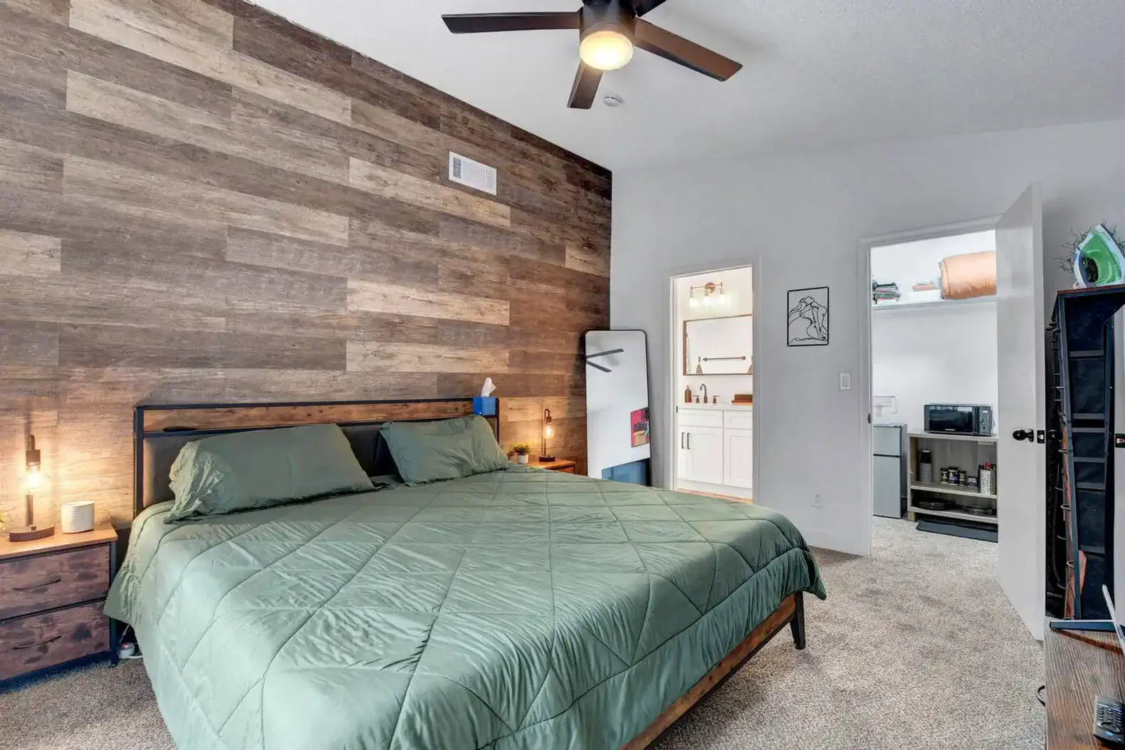 Cozy master bedroom with wooden accent wall and spacious closet