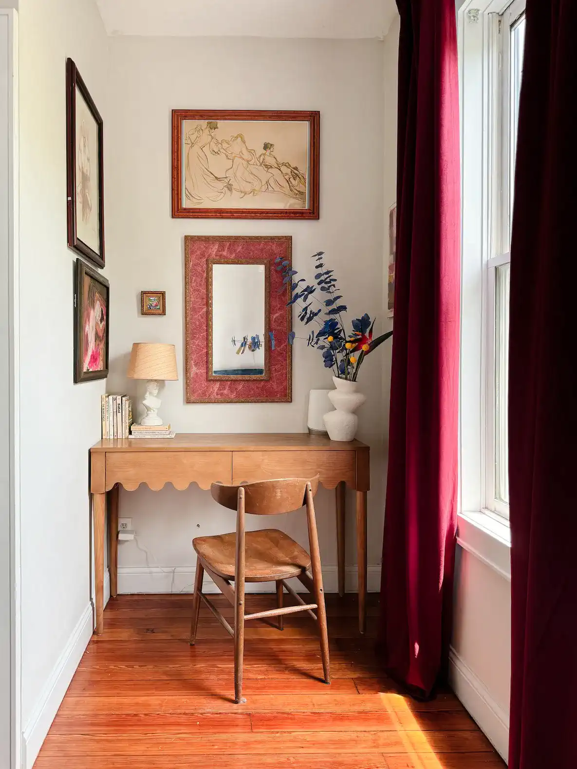 Cozy workspace with a wooden desk, chair, and decorative wall art