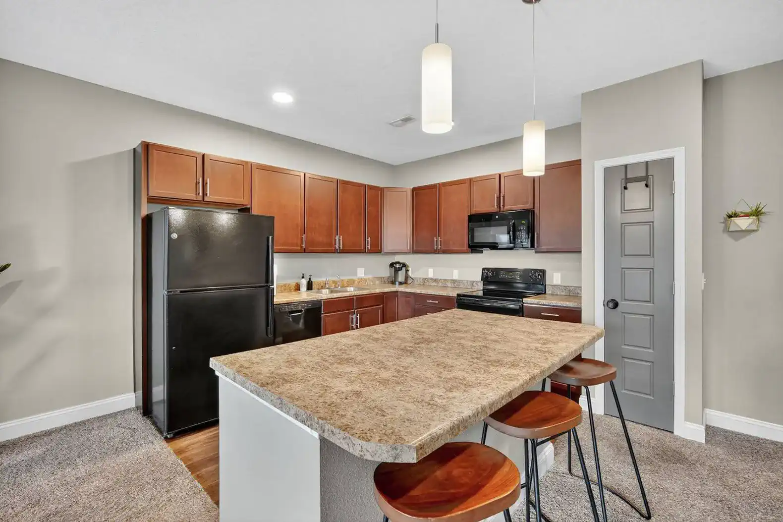 Open-concept living meets functionality with a full kitchen, bar seating for three, and cozy living room flow. Whether cooking, entertaining, or relaxing, this space blends comfort with conven