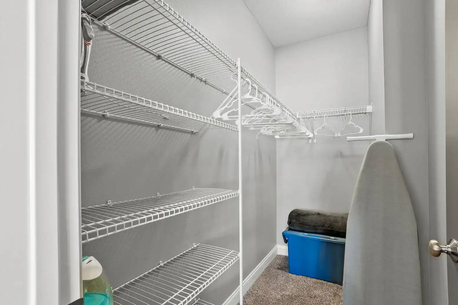 Spacious walk-in closet with shelving, hangers, extra linens, and laundry essentials—plenty of room to unpack, organize, and settle in comfortably for short or extended stays.