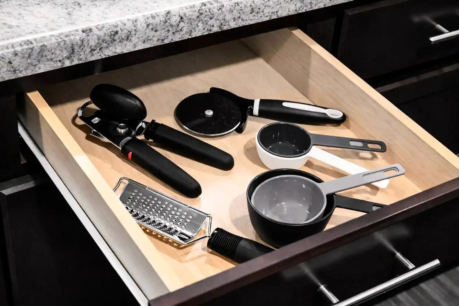 Kitchen drawers include measuring tools, graters and essentials to support any recipe.