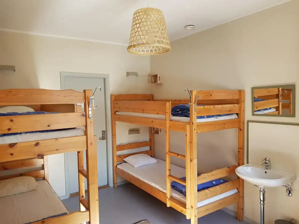 Bunk room featuring wooden bunk beds and a washbasin