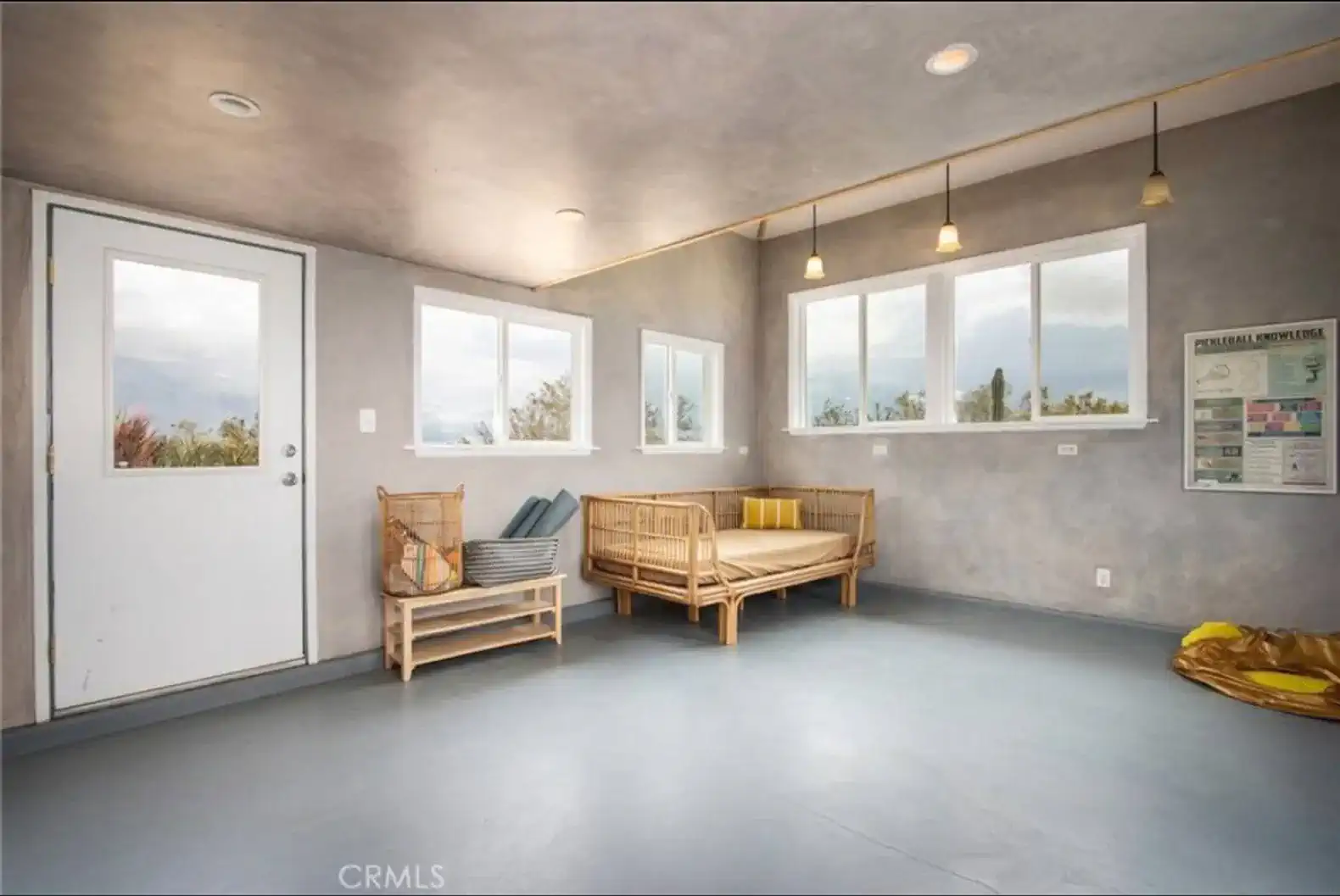 Bright room with large windows, minimalist seating, and a modern design