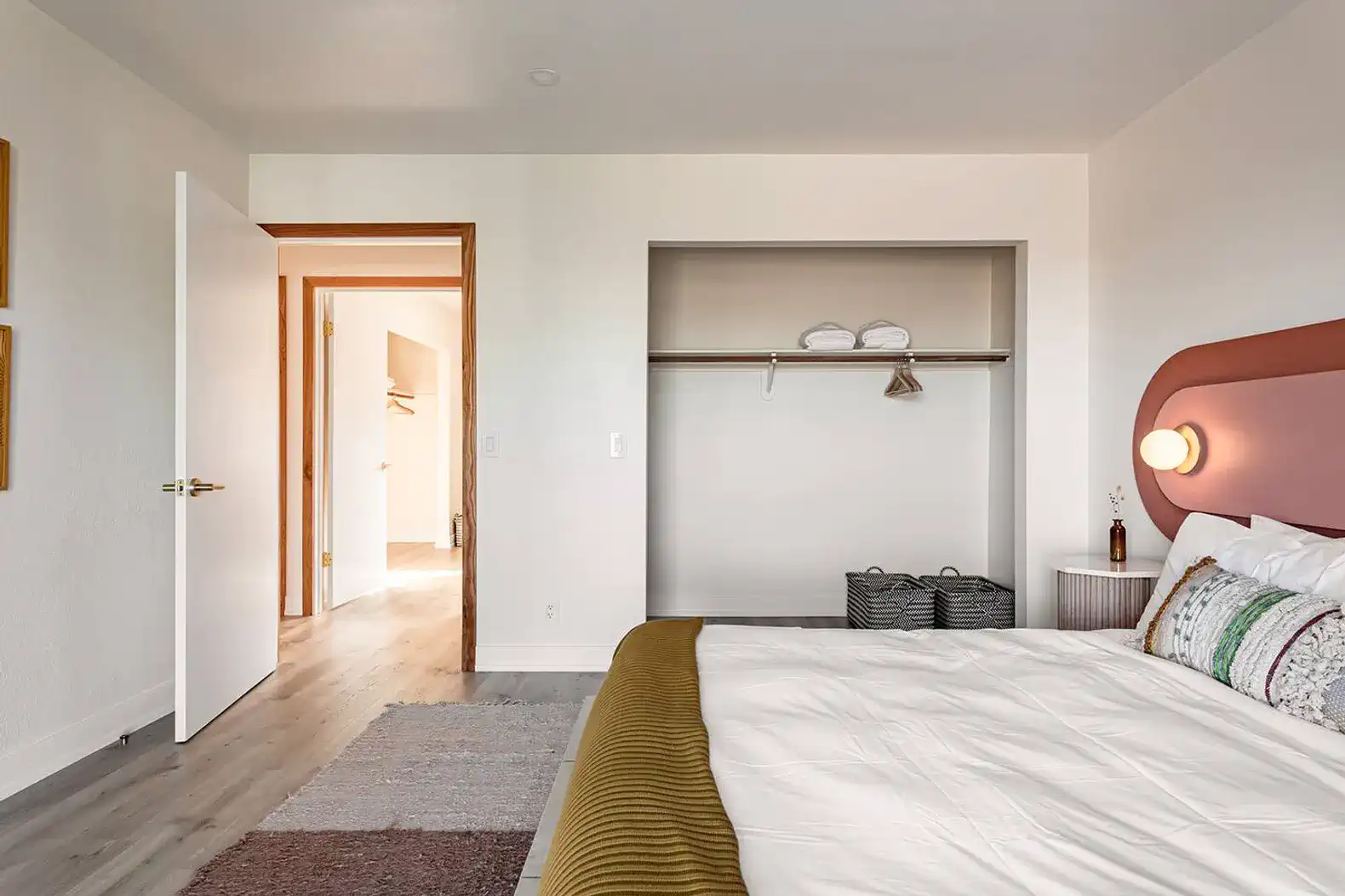 Cozy master bedroom featuring a large bed, modern decor, and a closet space