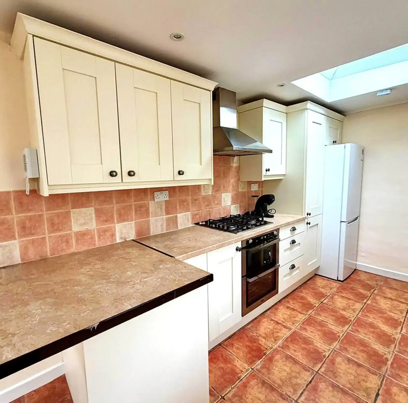 Bright kitchen with modern appliances and tiled flooring
