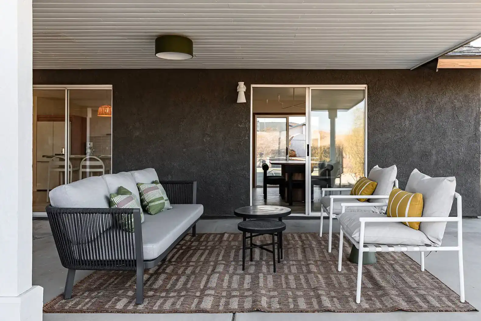 Cozy outdoor seating area with modern furniture and a rug