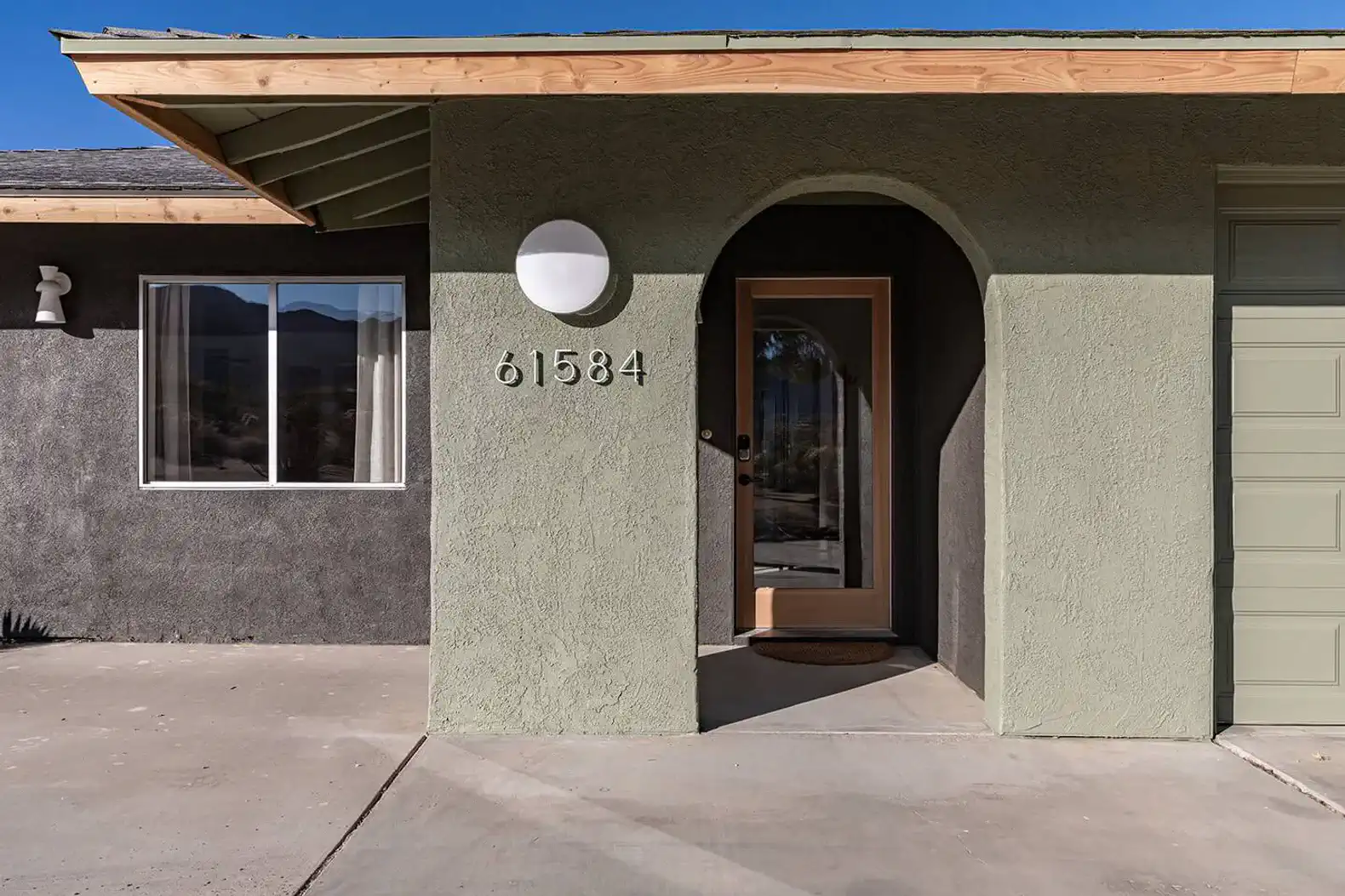 Welcoming entrance with a modern door and light fixture