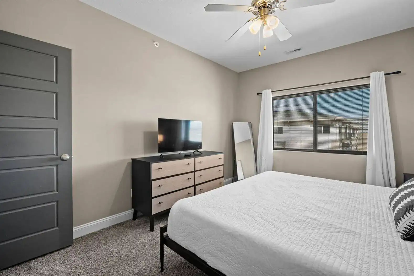 The bedroom offers a generous layout, natural light, and clean, uncluttered setup—simple, comfortable, and easy to settle into.