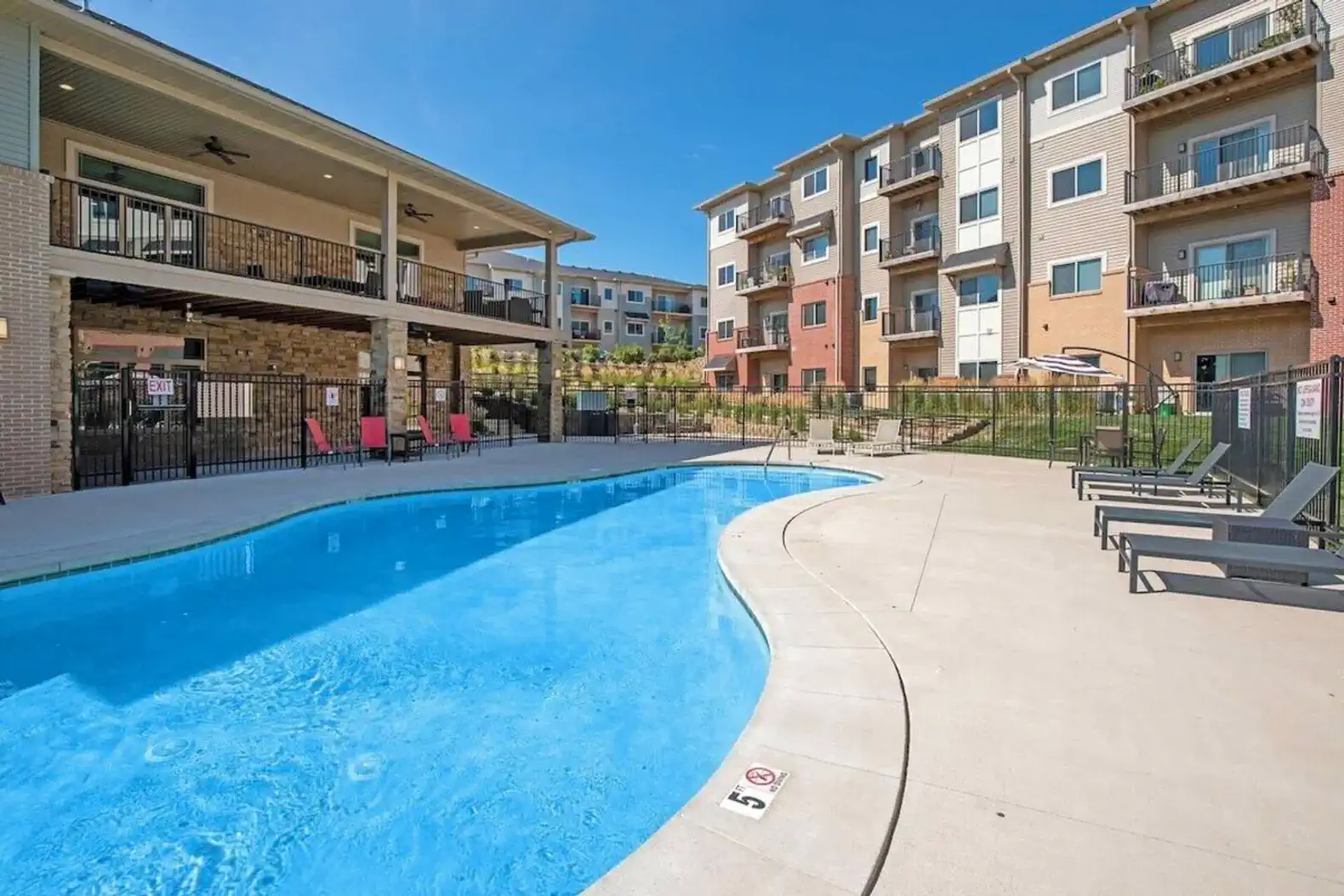 Resort-style community pool with plenty of lounge seating and sunny space to relax. A perfect spot to cool off, unwind, or enjoy a laid-back afternoon between outings.