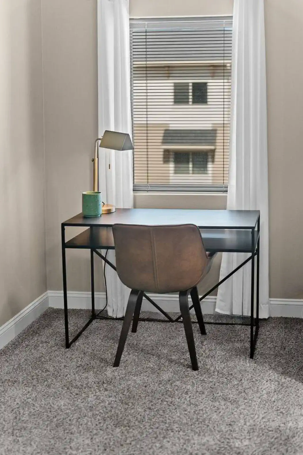 The office nook has a desk with a picturesque window to gaze out and distract yourself.