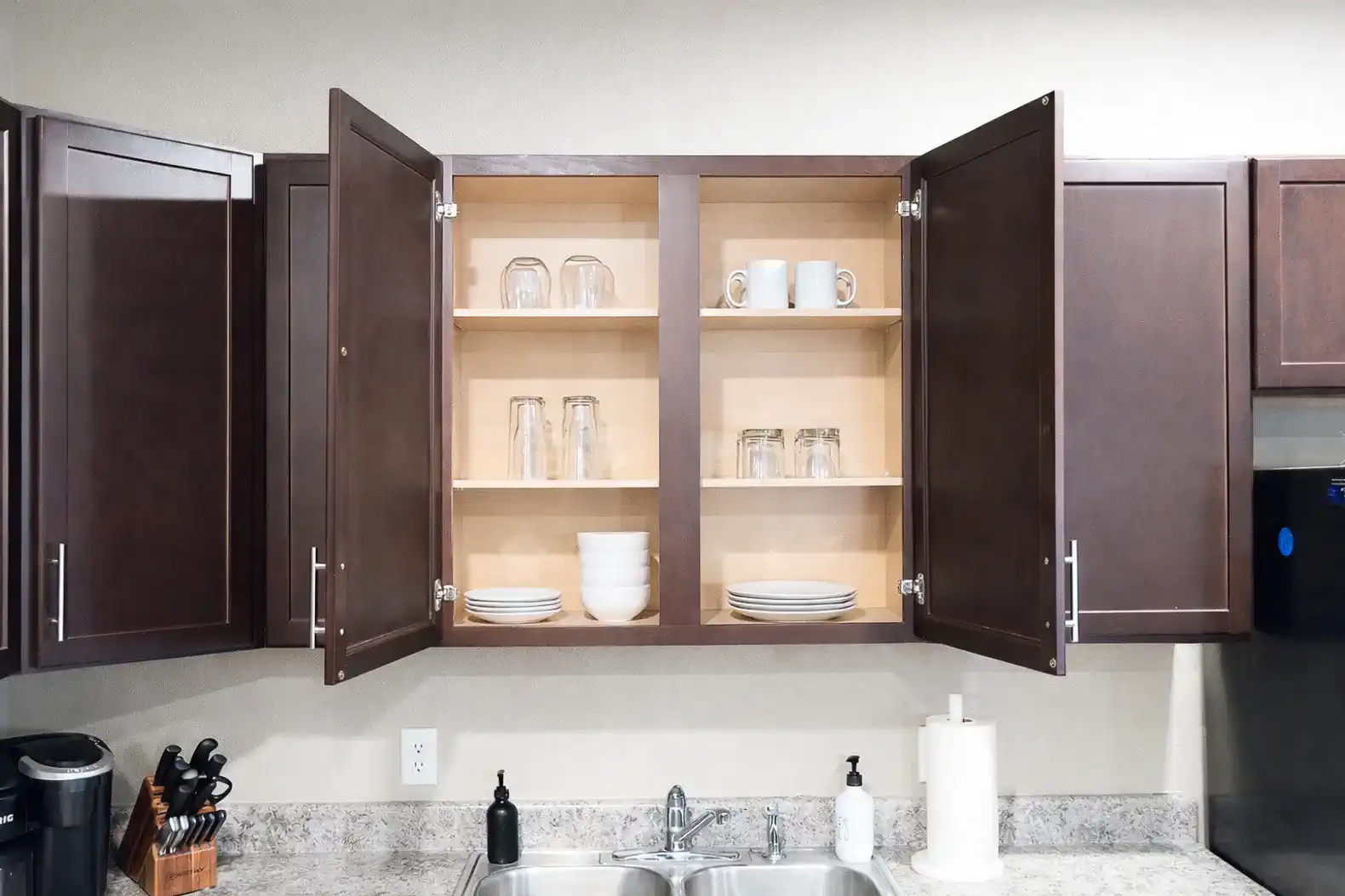 Cabinets are stocked with plates, bowls and glasses to comfortably serve everyone.