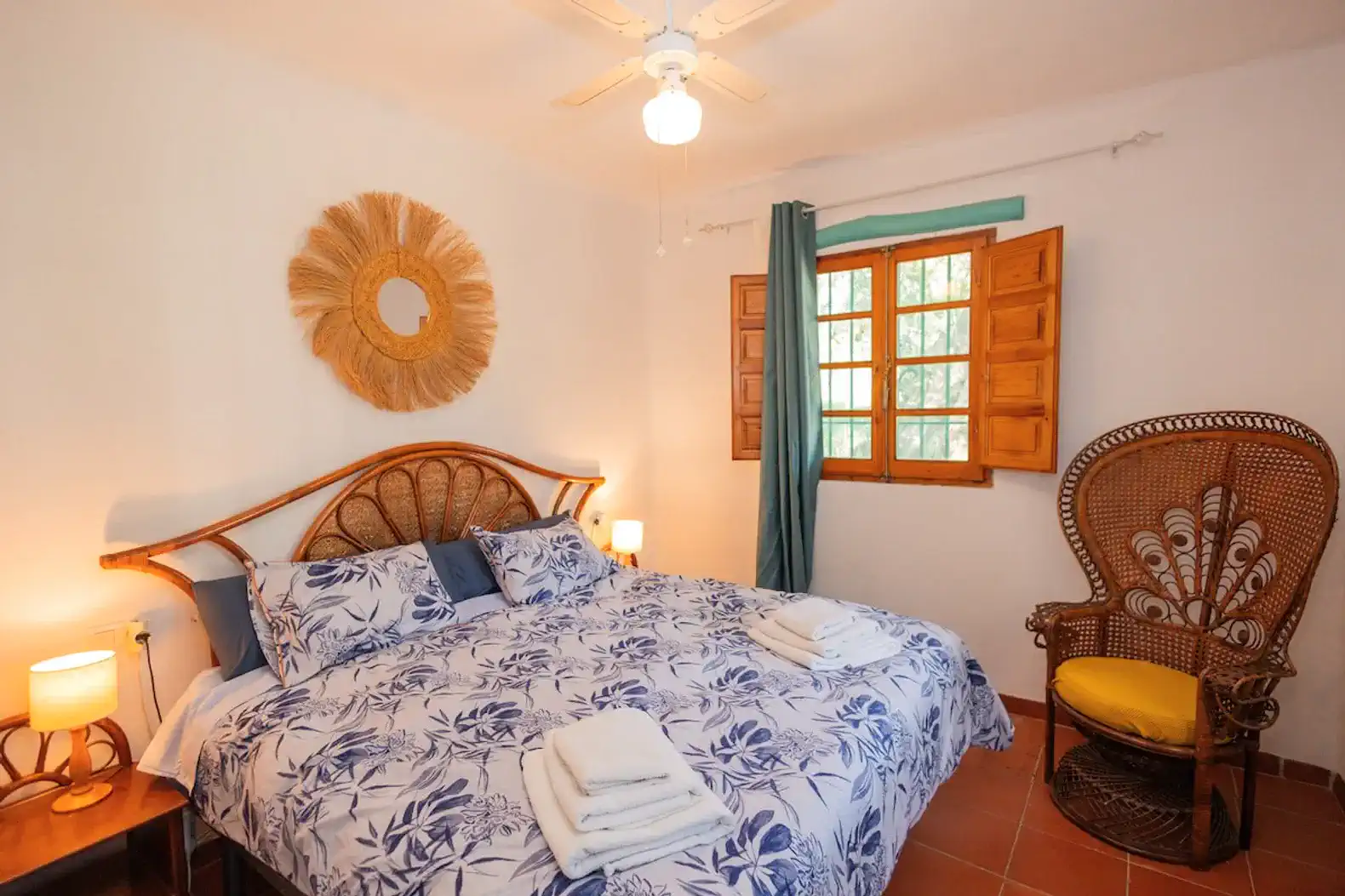 Cozy master bedroom with a large bed, decorative wall art, and natural light from wooden windows