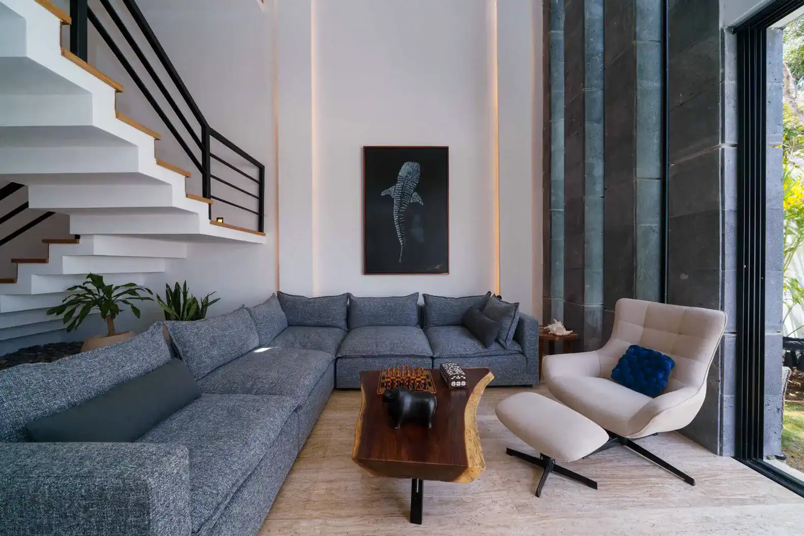 Spacious living room with modern furniture and large windows