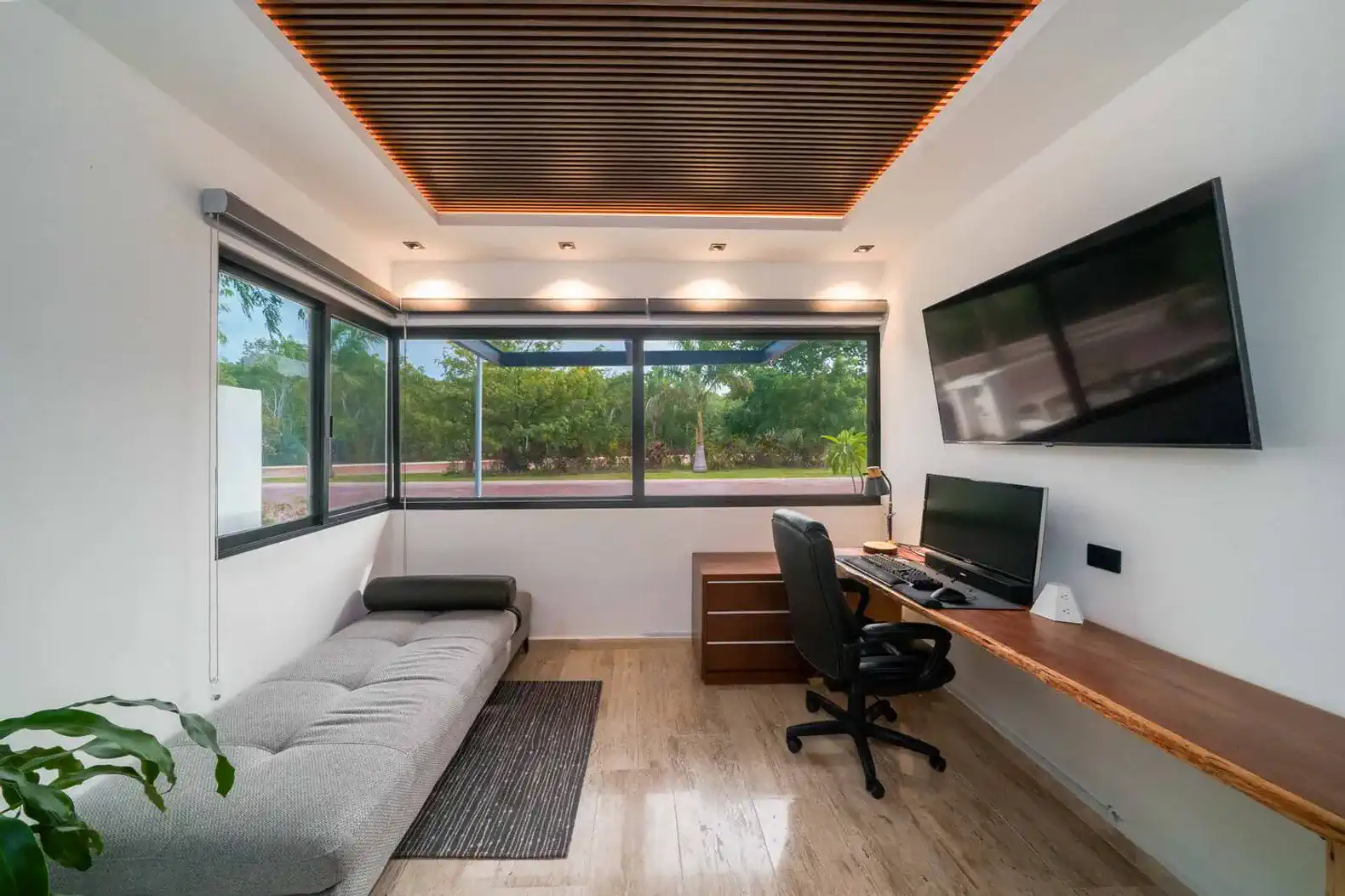 Suite 5: Designed for productivity and rest, featuring a fully equipped office space, sofa, and private bathroom.