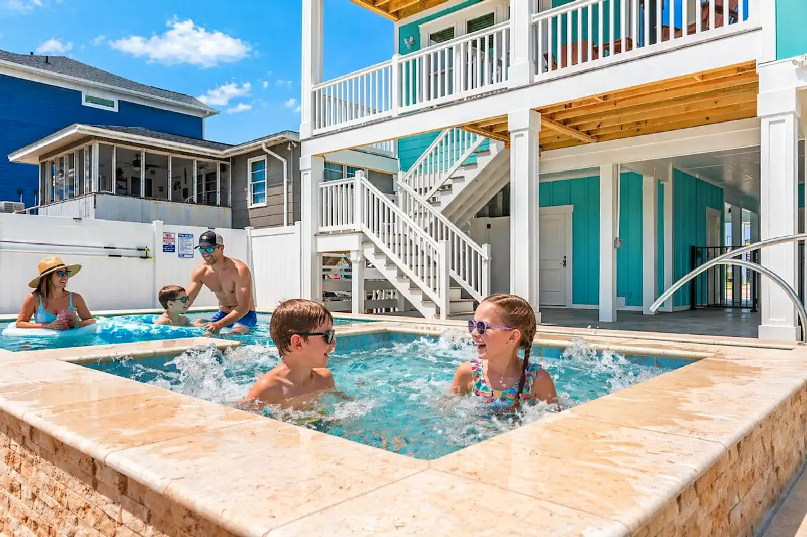 Children enjoying a hot tub with adults relaxing nearby in a vibrant outdoor setting