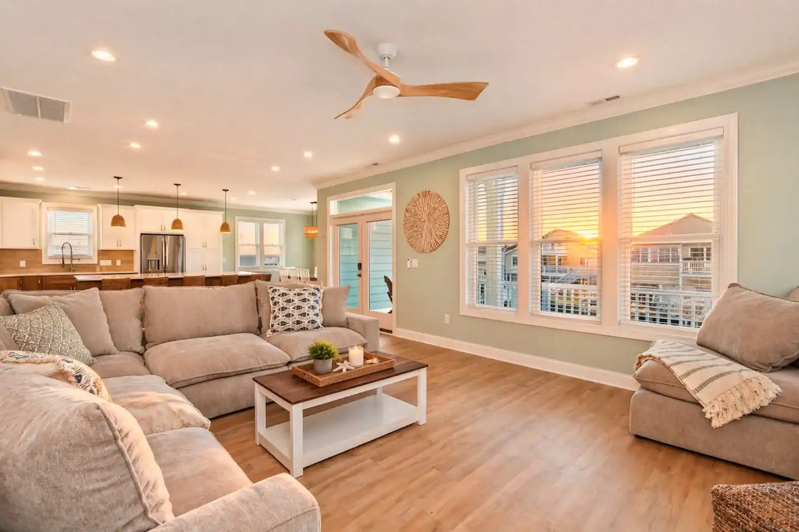Spacious living room with large sectional sofa and sunset views through windows