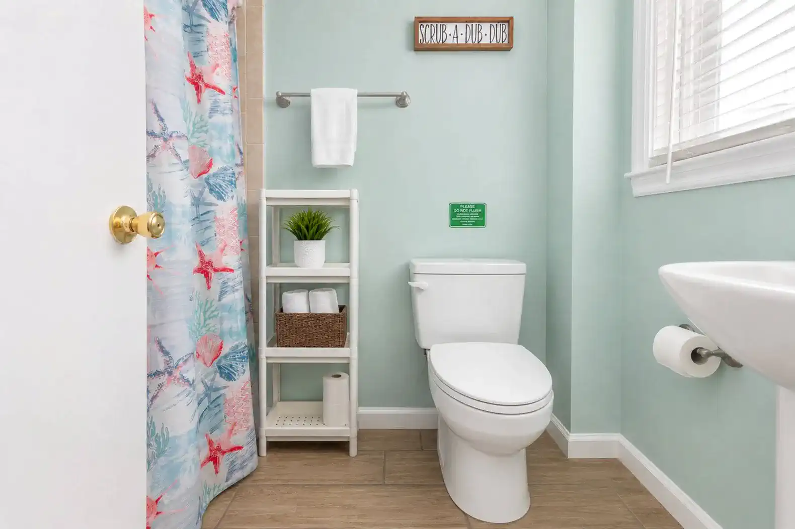 Bright bathroom featuring a colorful shower curtain and modern fixtures