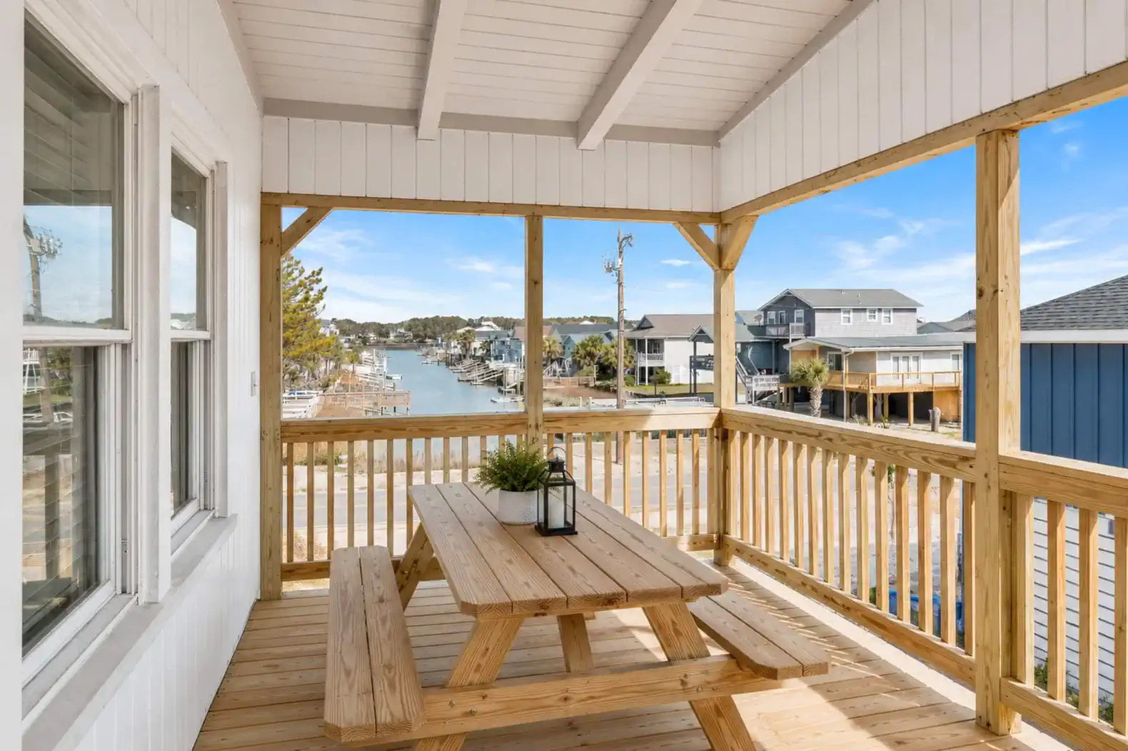 Bikini Top Balcony, overlooks the pool area and the channel to the left.  Has a picnic table and Rocking Chairs