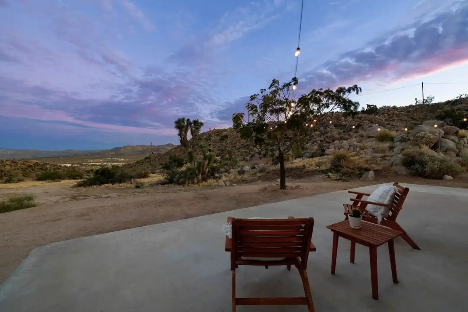 Cozy outdoor seating area with stunning desert views and colorful sunset sky