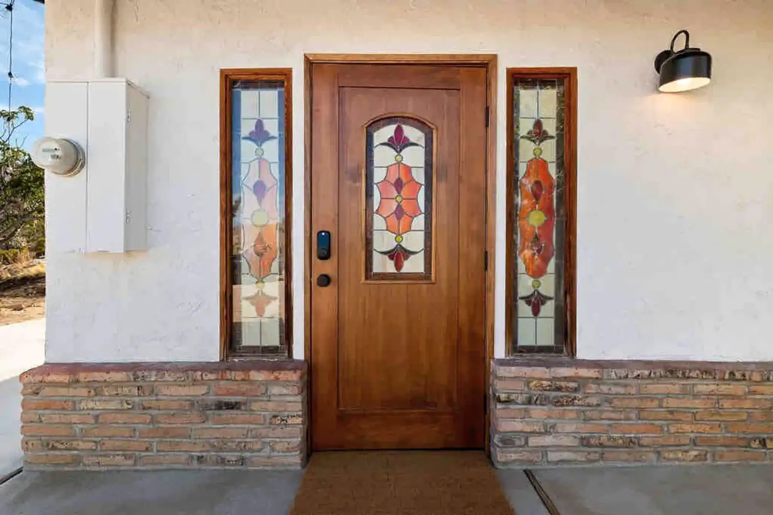 Charming entrance with a wooden door and colorful stained glass windows