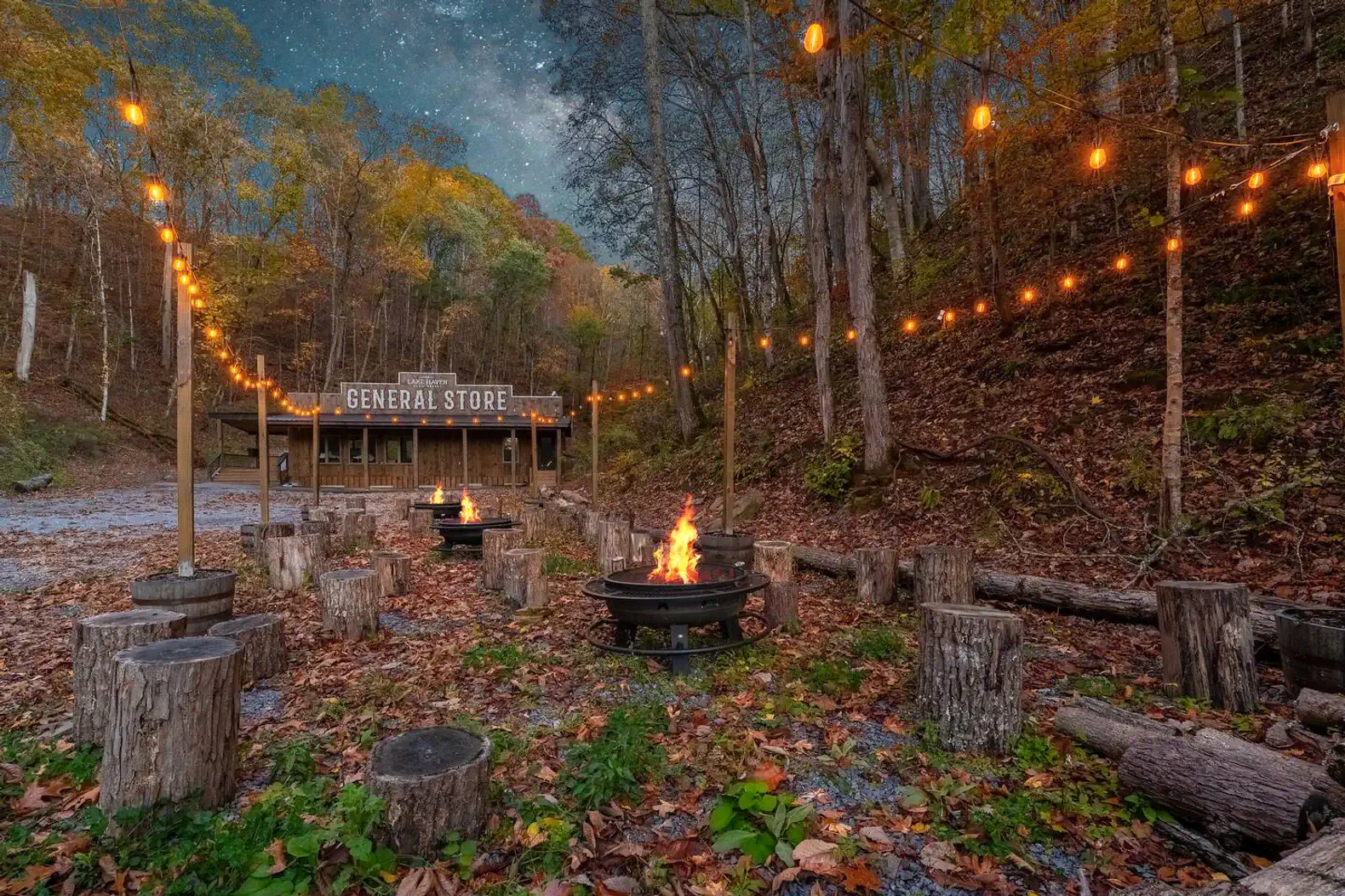 Cozy outdoor fire pit area surrounded by logs and string lights near a general store