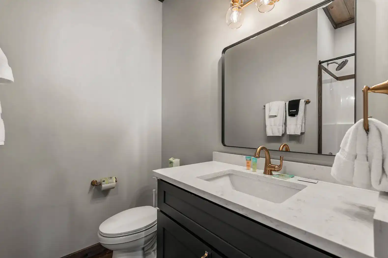 Modern bathroom with a sleek vanity, large mirror, and stylish fixtures