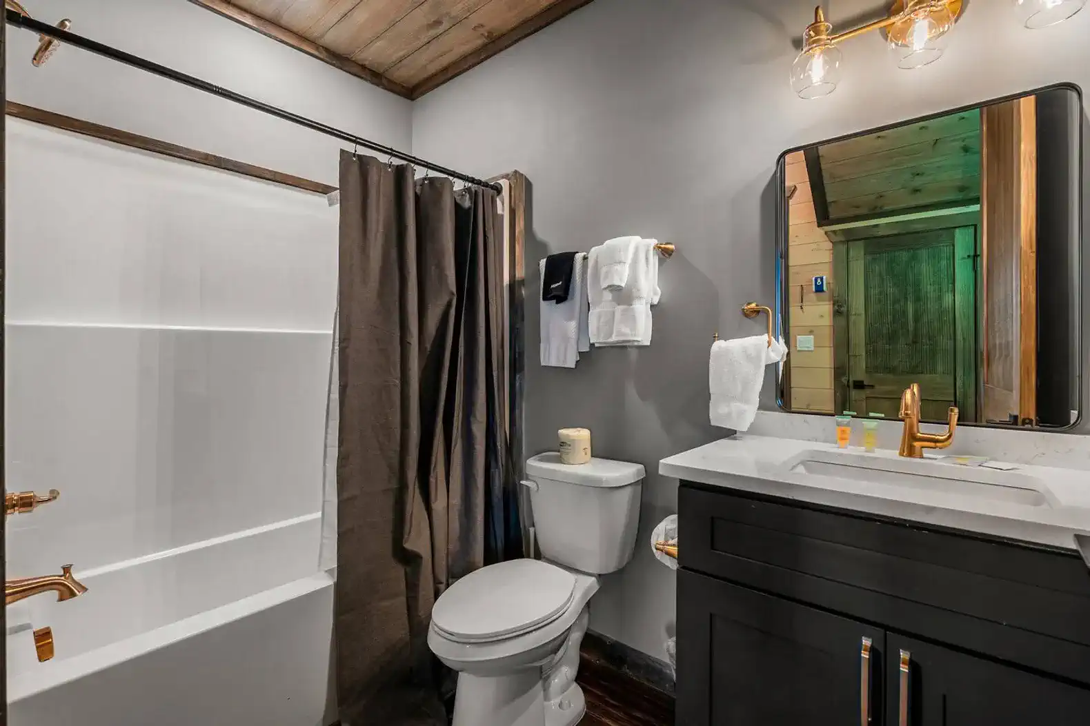 Modern bathroom with shower, toilet, and stylish sink area