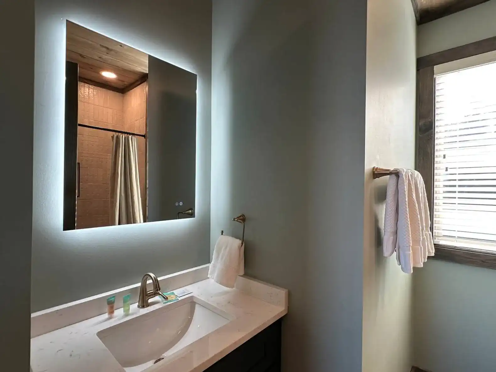 Modern bathroom with a sleek vanity and illuminated mirror