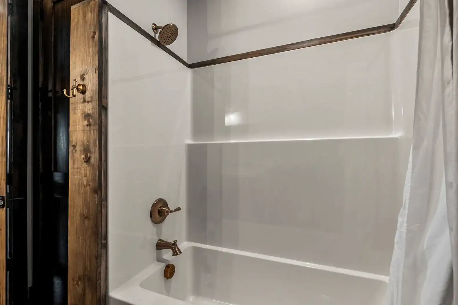 Modern bathroom with a sleek shower and rustic wooden accents
