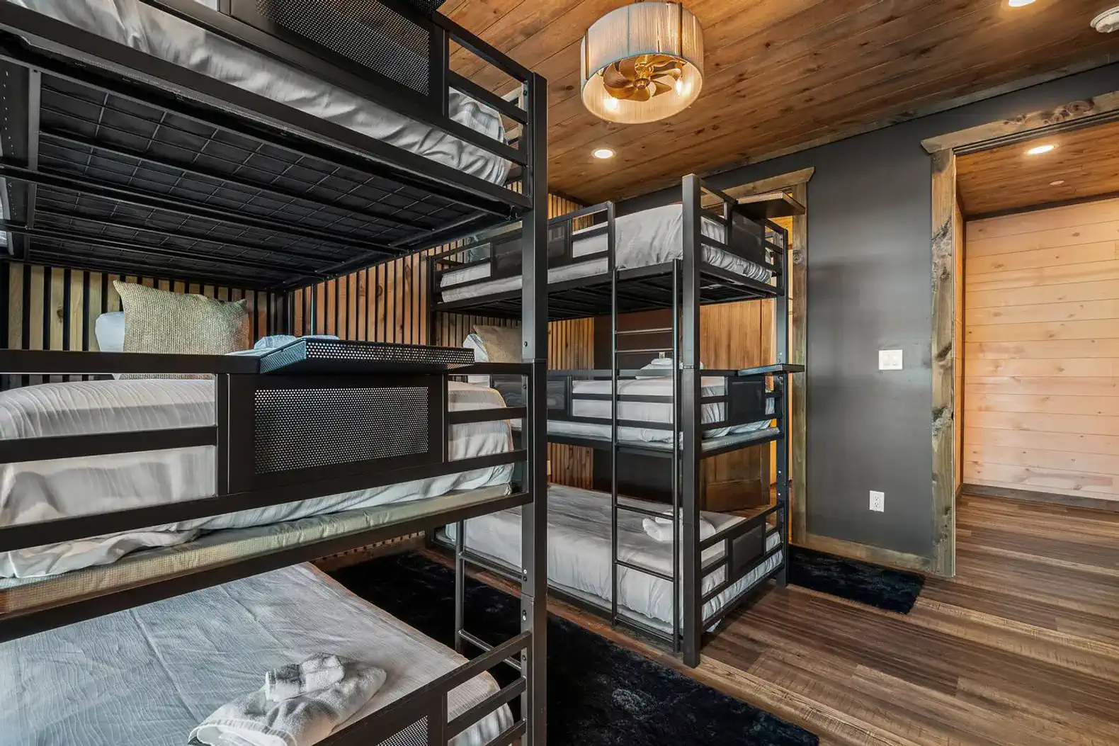 Bunk room featuring multiple metal bunk beds with wooden accents