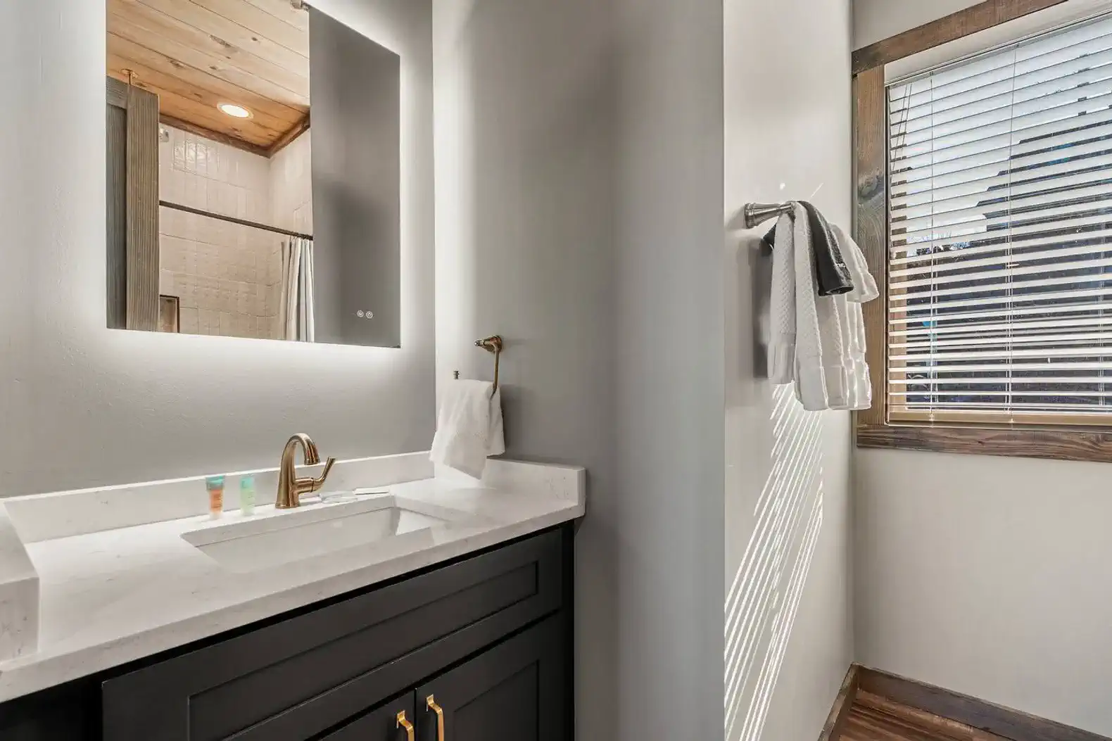 Modern bathroom with sleek vanity and natural light from window