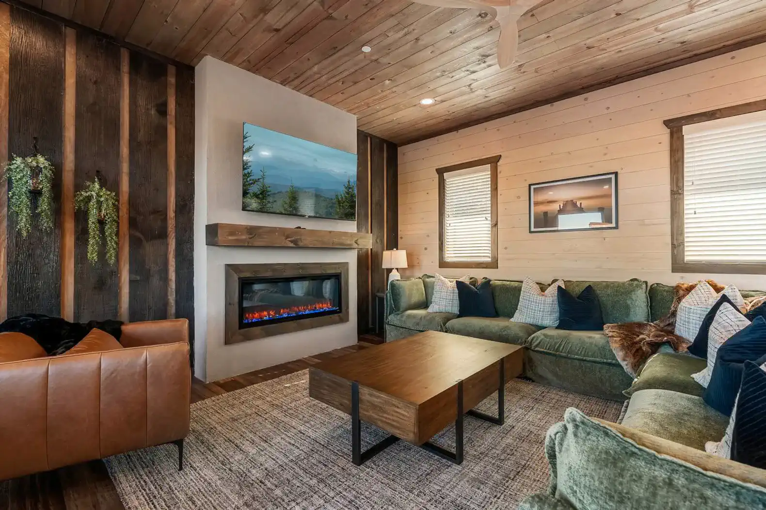 Cozy living room with a fireplace, large sectional sofa, and wooden accents