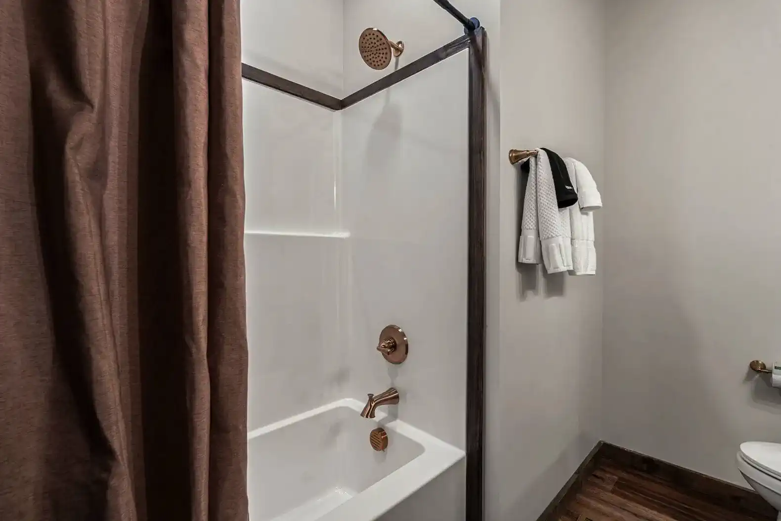 Modern bathroom featuring a shower and tub combination with stylish fixtures