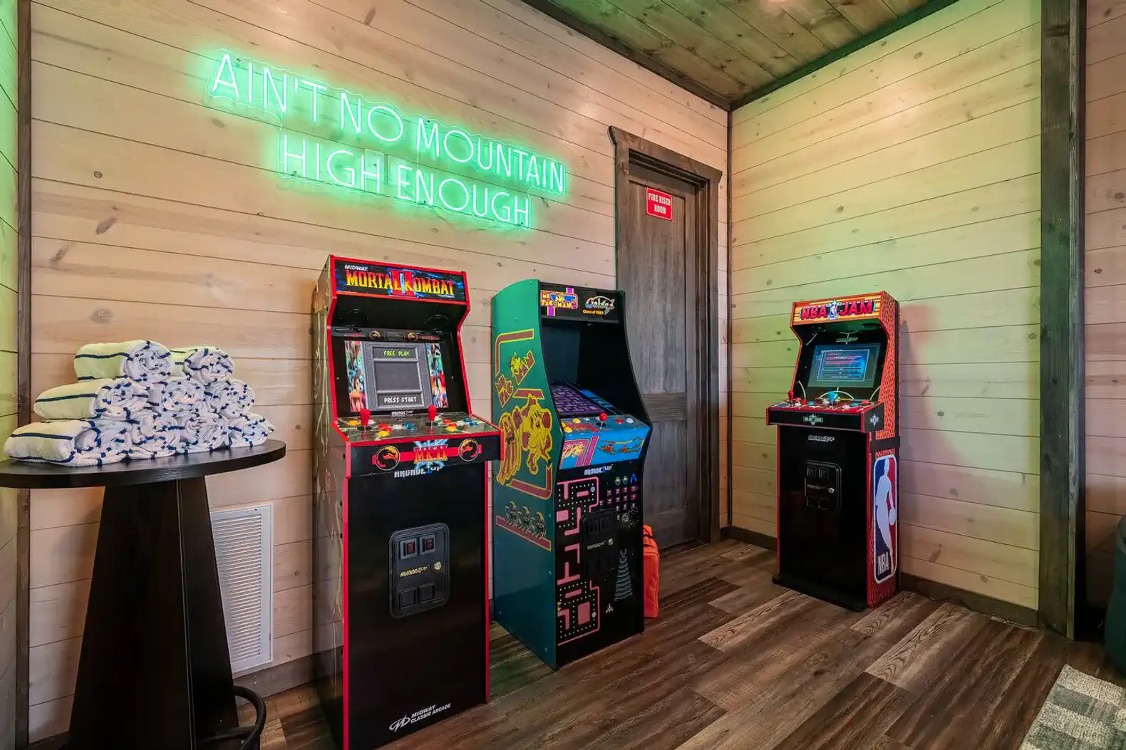 Colorful arcade games with neon sign in a cozy game room