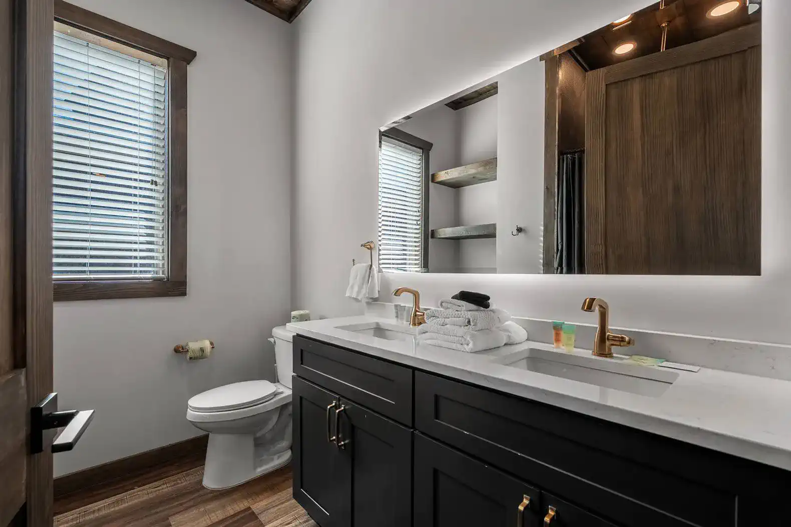 Modern bathroom with dual sinks, stylish fixtures, and natural light