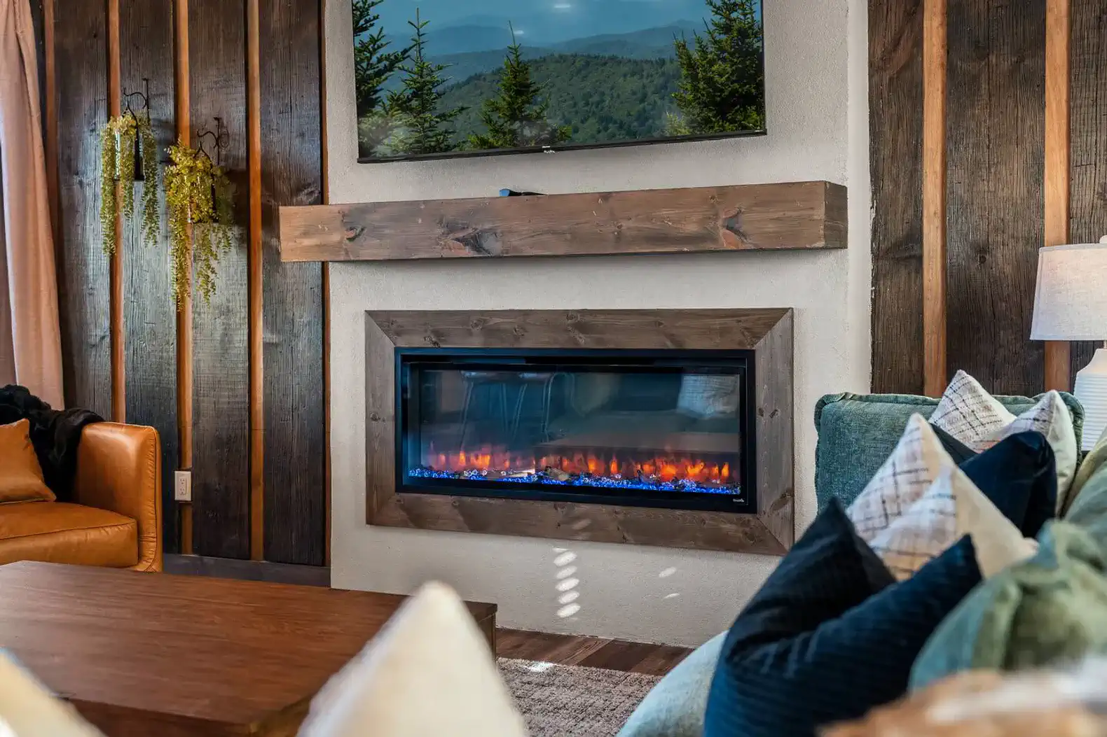 Cozy living area with modern electric fireplace and mountain view
