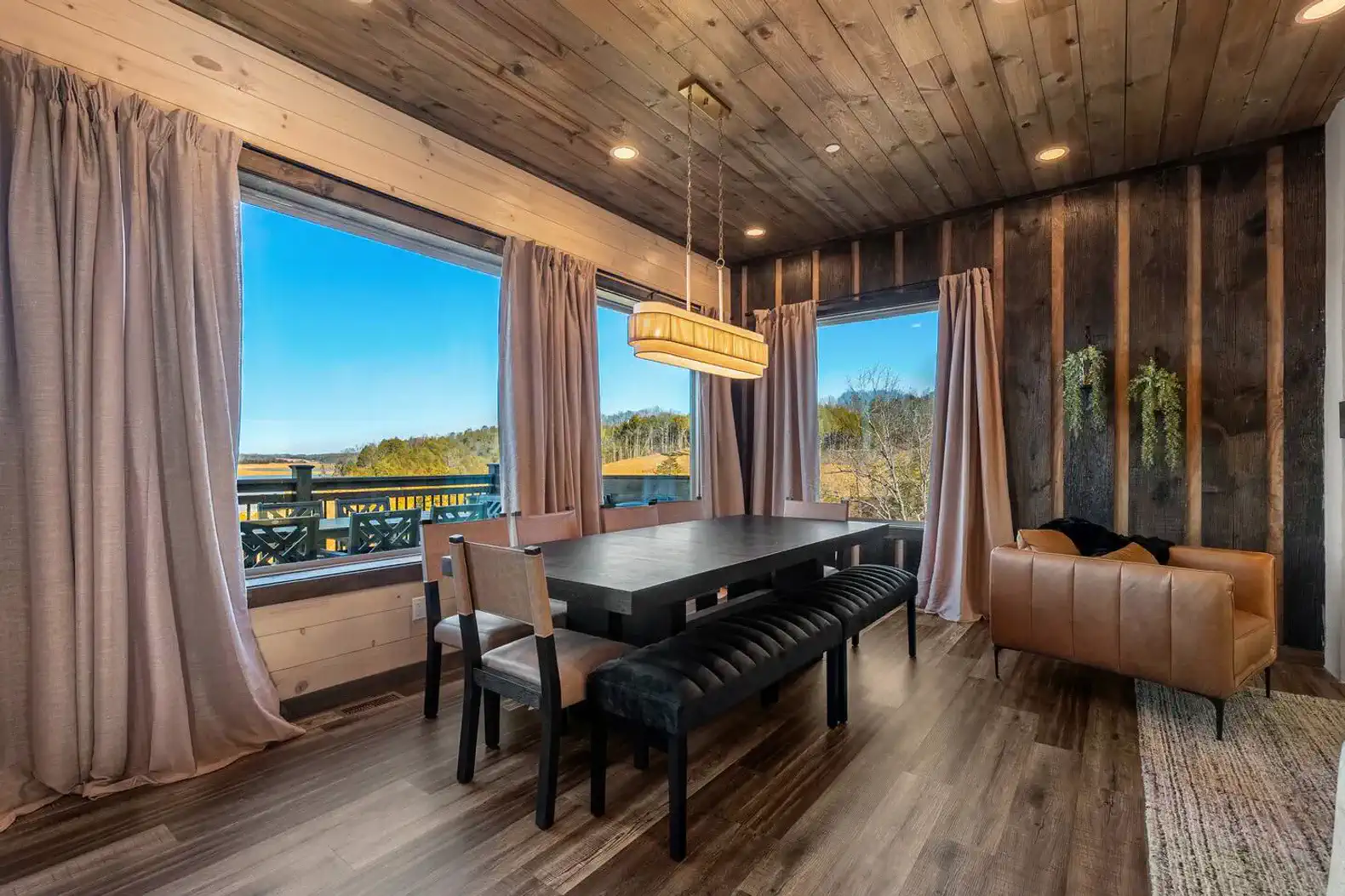 Stylish dining area with large windows showcasing lake views
