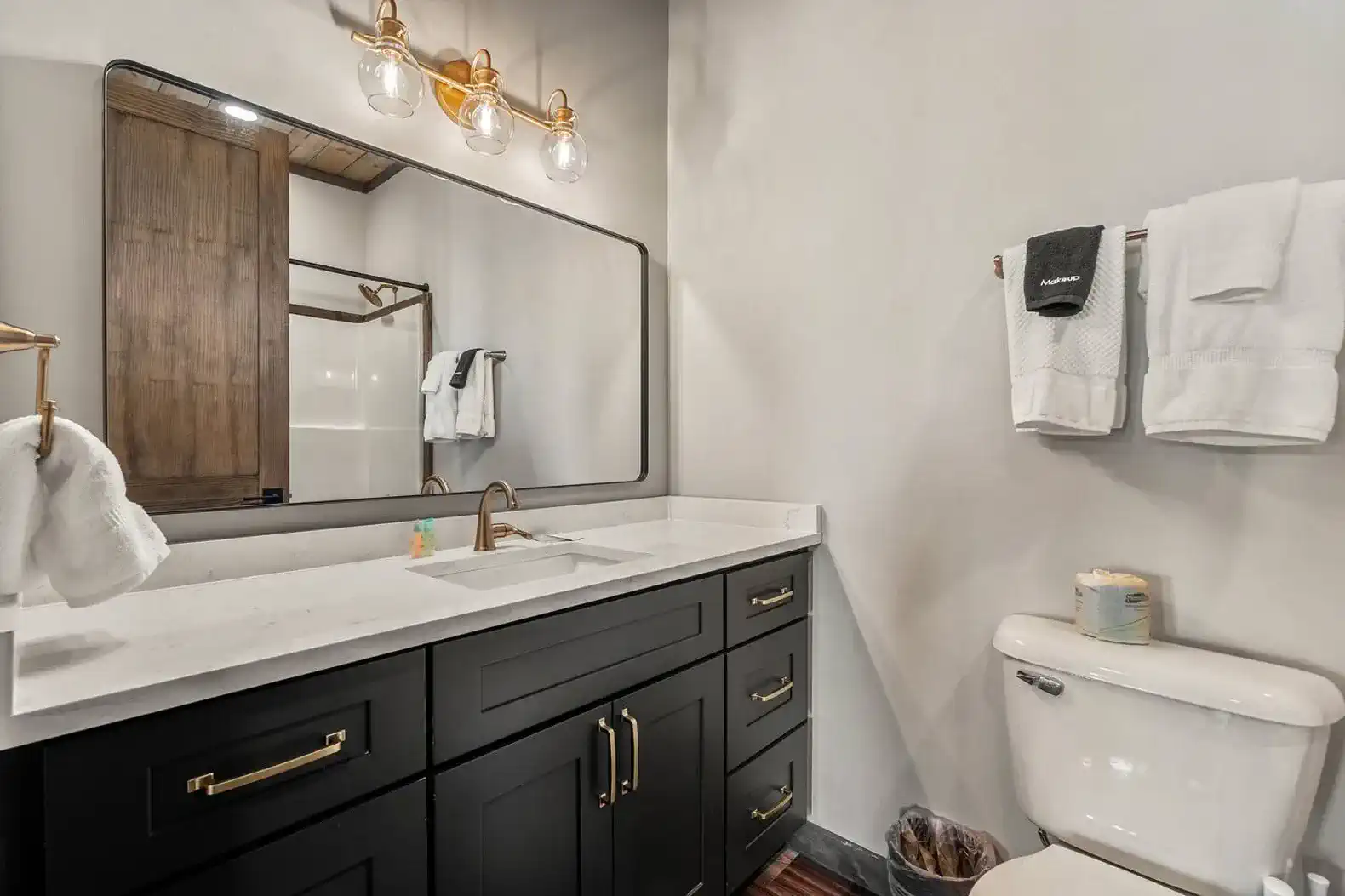 Modern bathroom with a stylish vanity, large mirror, and elegant lighting