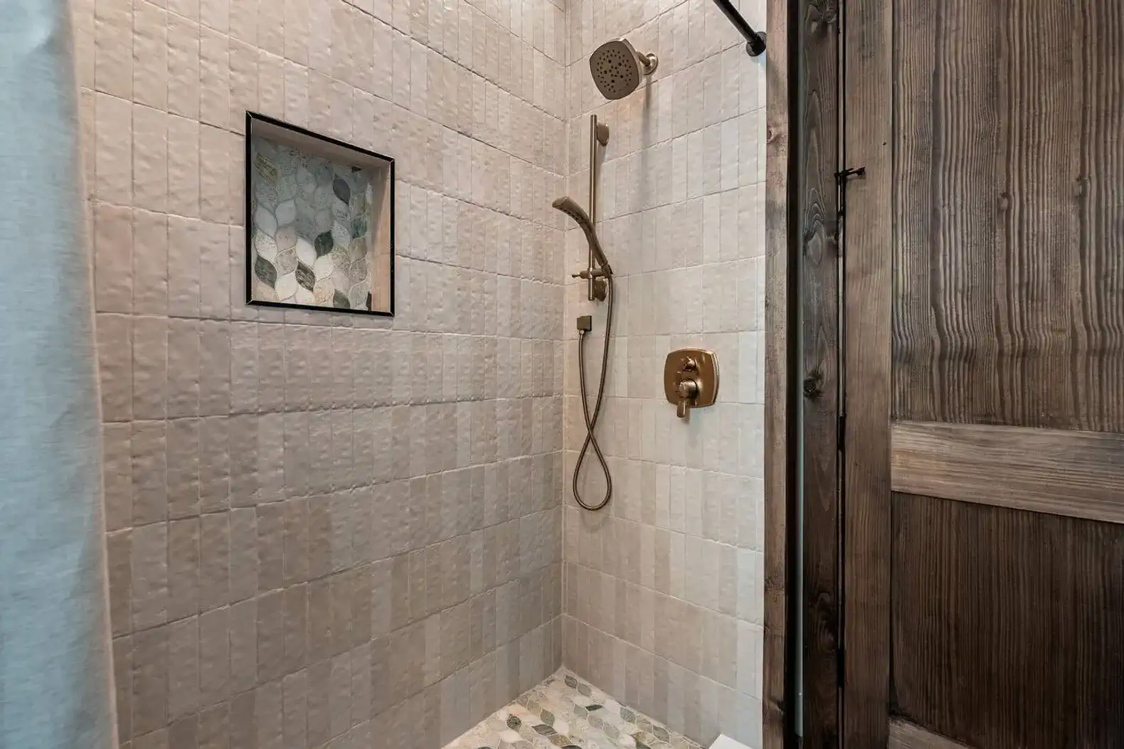 Stylish shower with modern fixtures and decorative tile accents