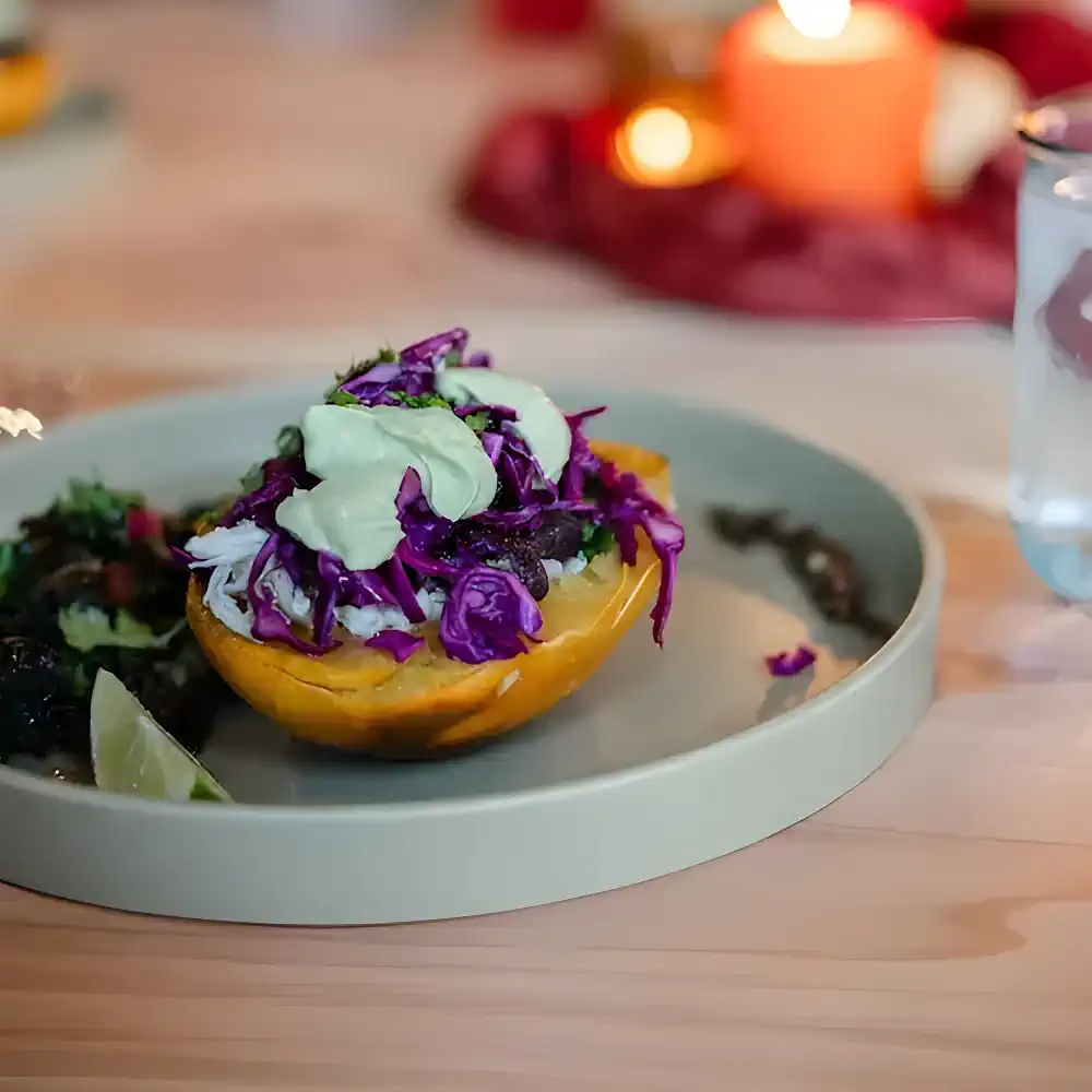 A beautifully plated dish featuring shredded cabbage and sauce on a halved squash