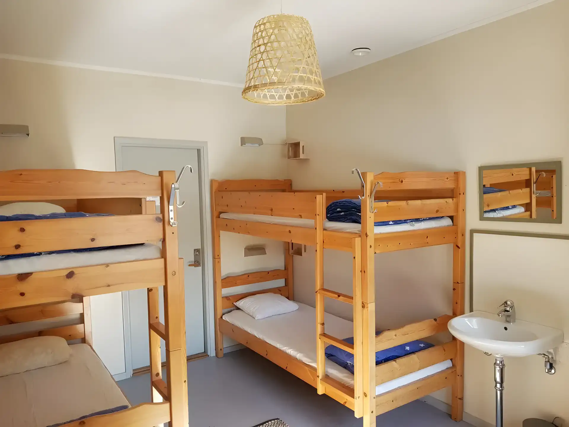Schlafzimmer mit Etagenbetten aus Holz und einem Waschbecken